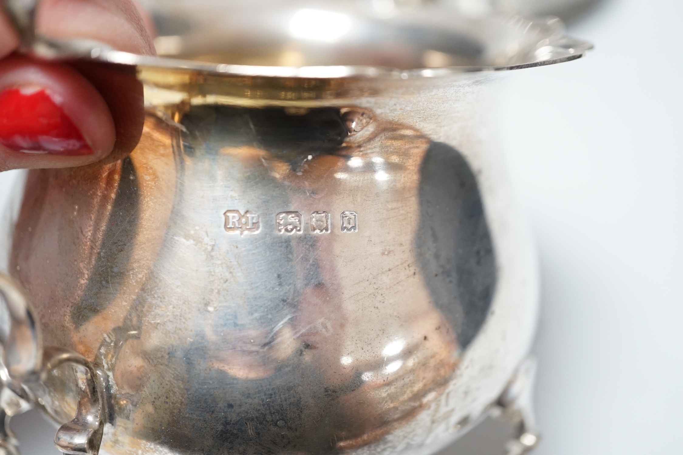 An 800 white metal plate, 24.8cm, a George V silver two handled bowl, a silver ashtray, six silver condiments, two 800 tots and minor plated ware, 24.1oz.